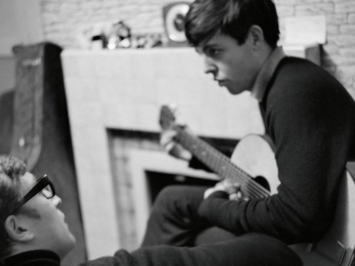 John Lennon (l) and Paul McCartney (r) writing at 20, Forthlin Road